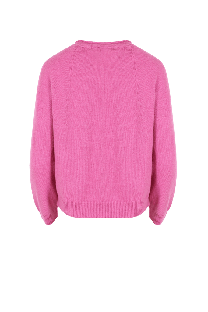 Olga de Polga Kyoto cardigan in pink colour. This cardigan is in a soft fine knit, with a round neckline, button front, dropped shoulder and long sleeves in a hip length. Back view
